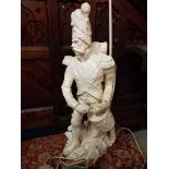 An early 20thC figural plaster table lamp depicting a Napoleonic military drummer raised on a