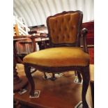 A French style walnut button-back open armchair with serpentine over stuffed seat,