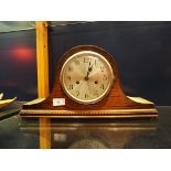 An oak cased Wellington hat shaped clock with silvered dial and Arabic numerals