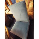 An early 20thC blue velvet upholstered bedroom chair raised on square supports