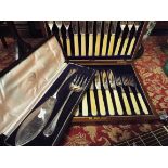 A walnut cased canteen of fish knives and forks together with a cased set of silver plated fish