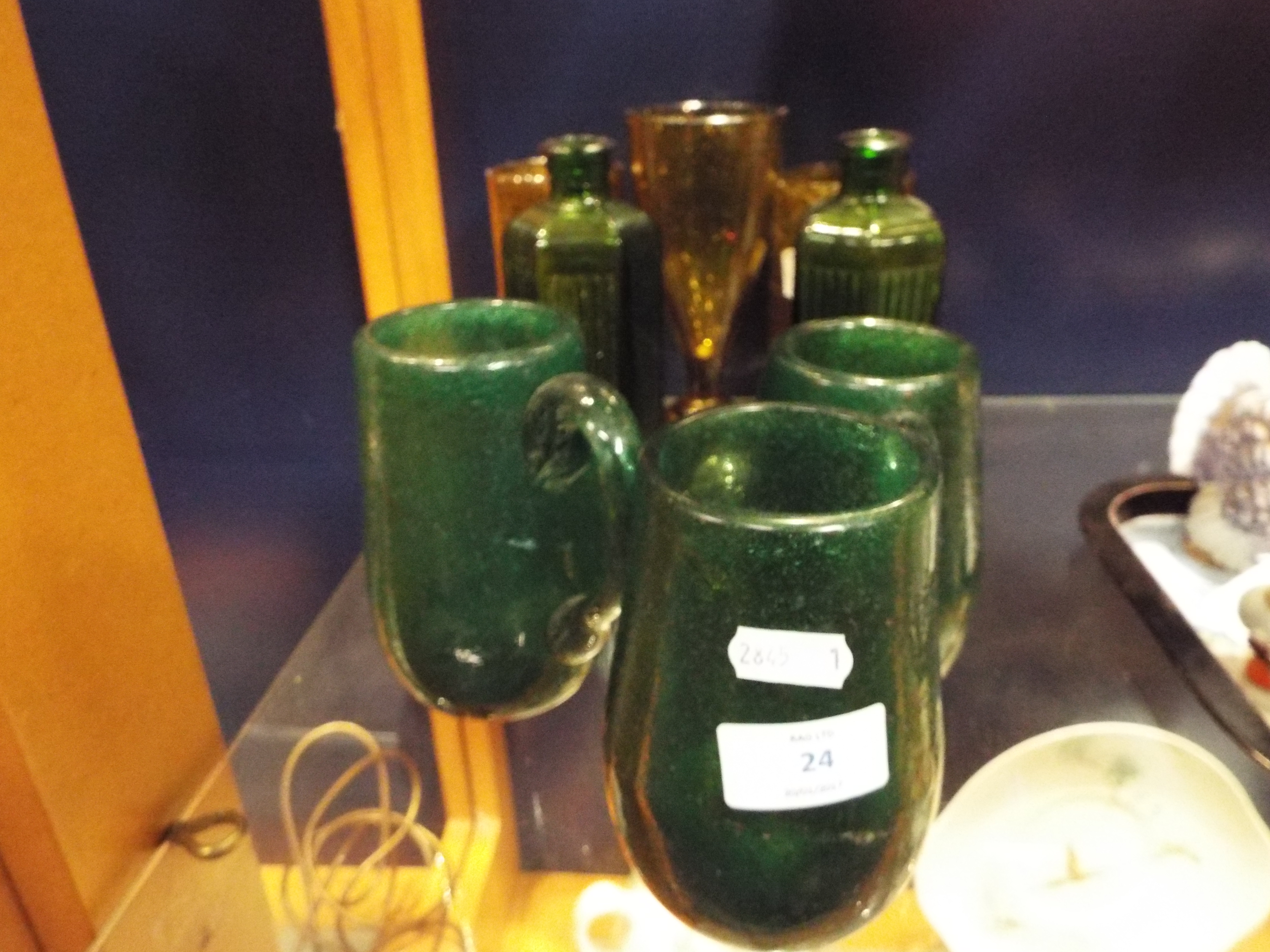 Six vintage hand blown amber and green glass tankards and beakers together with a pair of Victorian