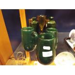 Six vintage hand blown amber and green glass tankards and beakers together with a pair of Victorian