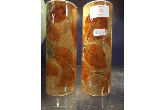 A pair of Royal Doulton cylindrical stoneware leaf vases (one restored to rim)