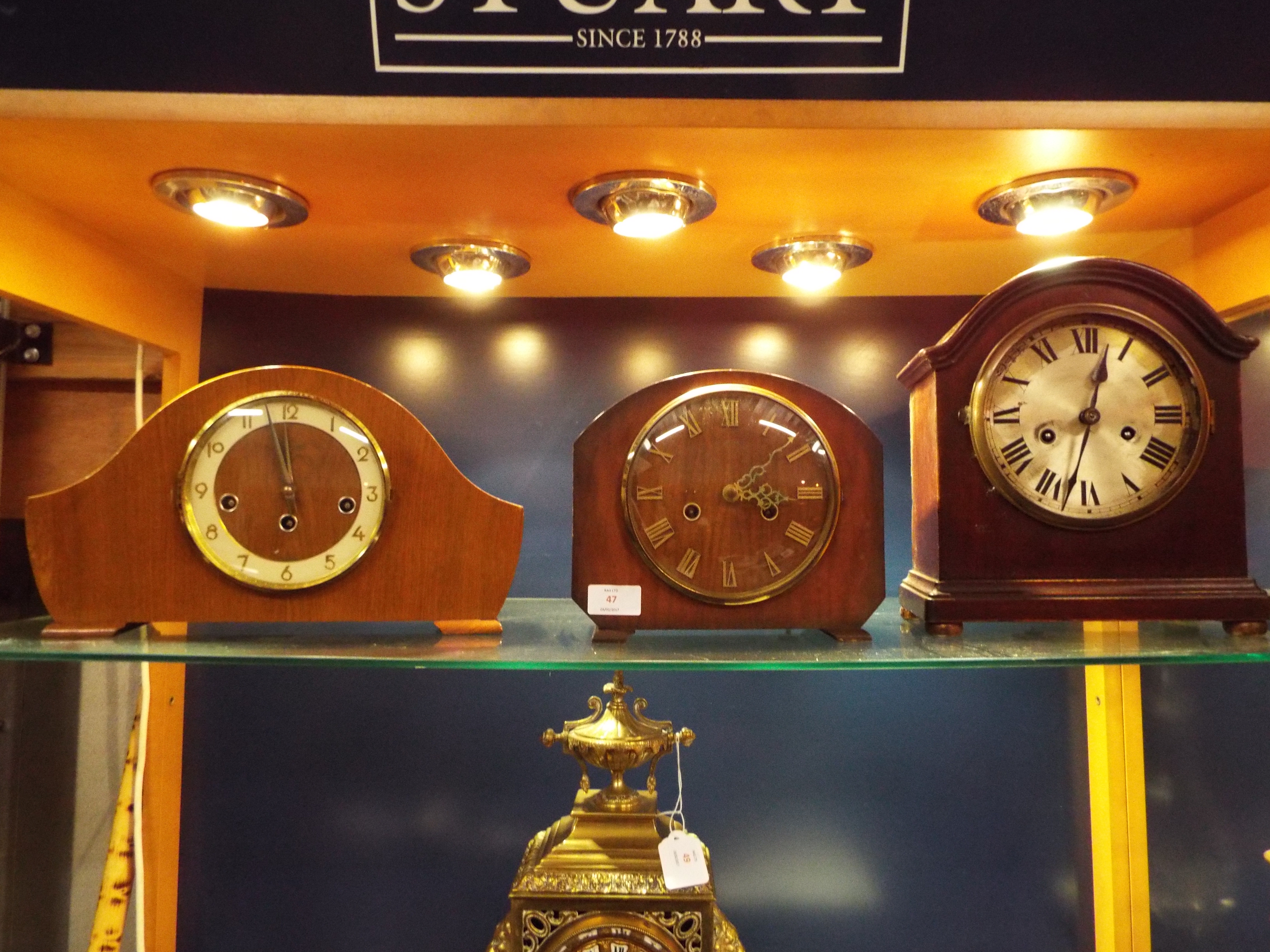 A 19thC mahogany cased mantel clock with silvered dial and Roman numerals,