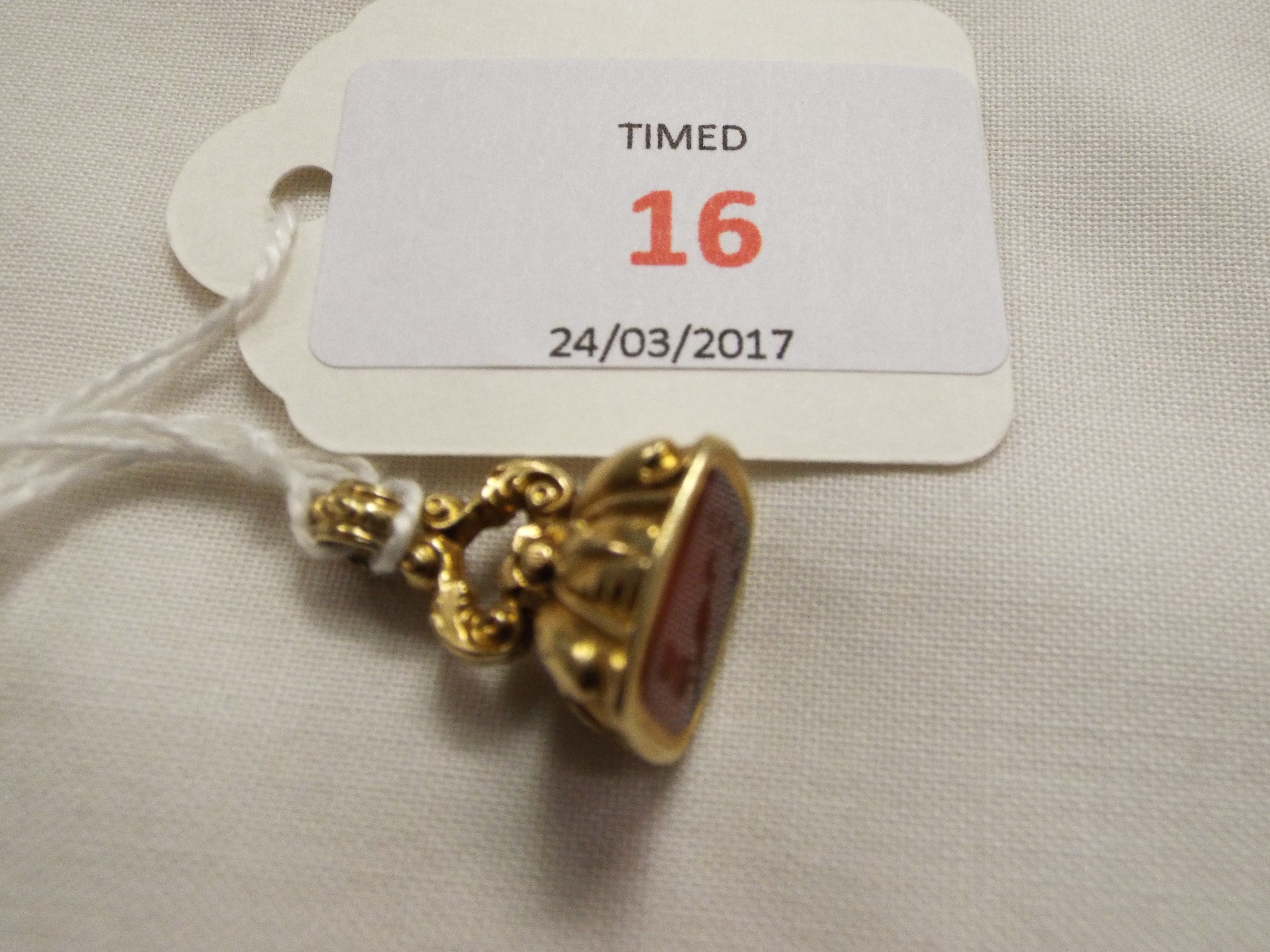 An antique gold fob with chased decoration,