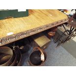 A large Victorian oak dining table having lion mask carvings to the frame and carved legs