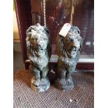 A pair of weathered stoneware seated lions approx 19.
