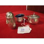 A Birmingham 1914 silver three piece condiment set with blue glass liner
