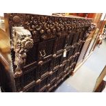 A 16thC style mahogany marriage chest heavily carved with flowers and scroll amongst blind fretwork
