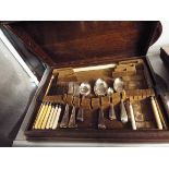 A 1930s oak cased part canteen of silver plated cutlery