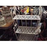 An ornate white painted three tier folding plant stand decorated with butterflies