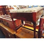 An Edwardian mahogany piano stool fitted with side drawer and raised on turned supports