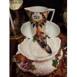 A French Art Deco wash basin and jug together with a continental lidded pot with applied birds,