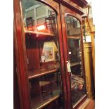 A Victorian mahogany bookcase cabinet the top having double glazed panelled doors enclosing three