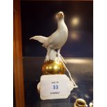 A Gerold Porzellan Bavarian porcelain figurine of a 'Pheasant' resting on a gold globe