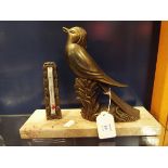 An Art Deco bronzed bird resting on a marble plinth with thermometer
