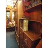 A pine dresser the top having two plate racks above two short drawers with two cupboards under