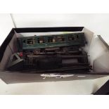 An early 'O' gauge green painted carriage, a Hornby buffer, metal track,