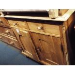 A Victorian painted and tripped pine cabinet fitted with two short drawers with cupboards below