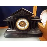 A Victorian slate mantle clock with enamel dial,