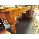 A pine kitchen table on turned supports 39" long x 32" wide x 29.