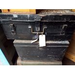 Two black painted military tin trunks