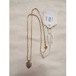 A 9ct gold diamond set pendant and chain