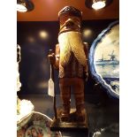 A circa 1900's carved wooden nutcracker figure of a woodsman in working order