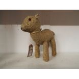 An antique Merrythought straw filled lamb with glass eyes and label to foot