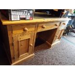 A pine pedestal desk with green leather inset,