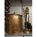 A brass coal bin and matching fire iron