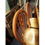 A set of four painted spindle and splat back kitchen chairs with beech seat
