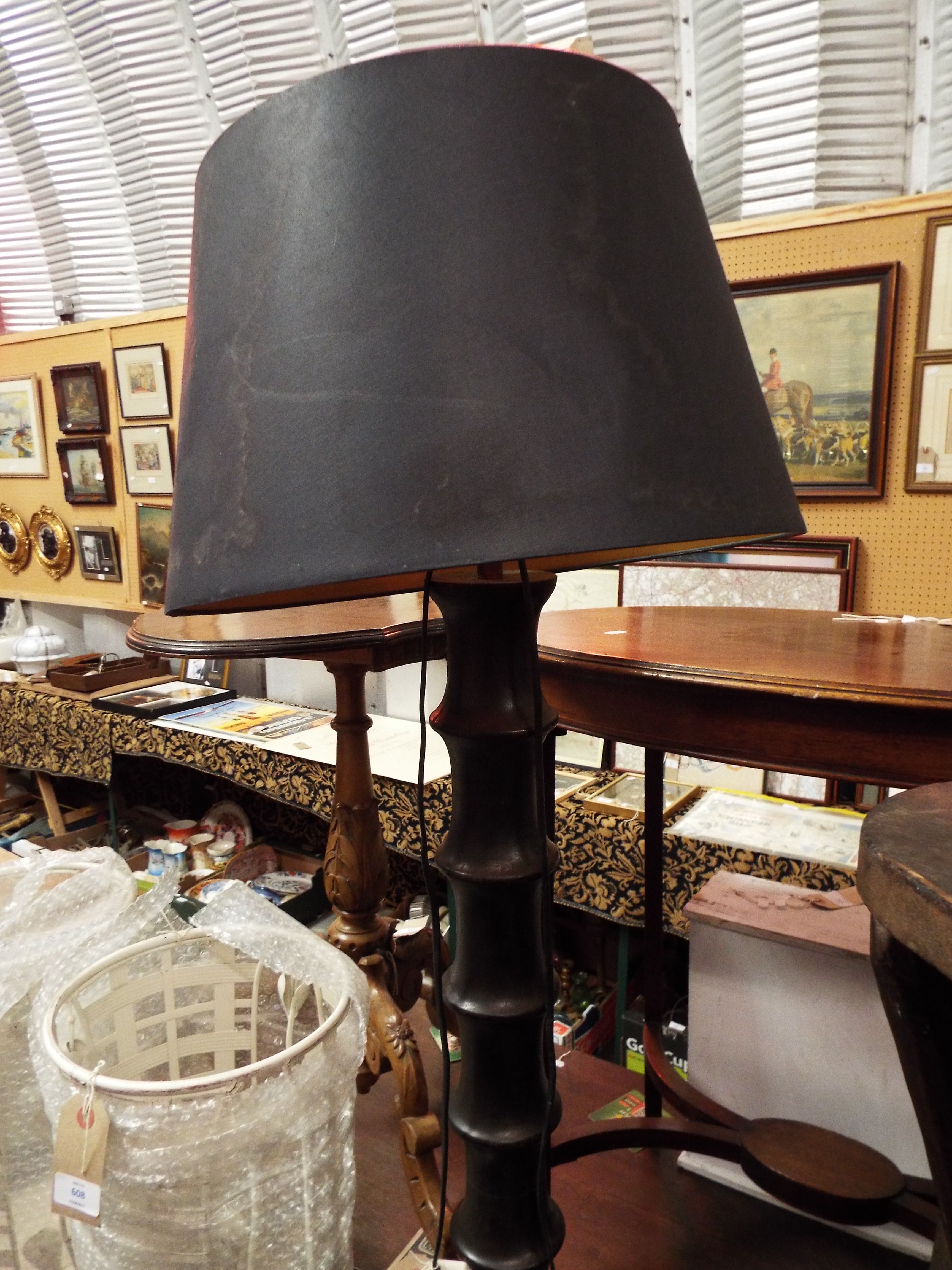 An ebonised turned standard lamp