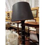 An ebonised turned standard lamp