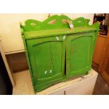 A green painted satinwood two door wall cabinet
