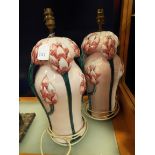 A pair of Italian china table lamps with applied artichoke decoration,