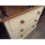 An early cream painted satinwood chest of three long graduated drawers each fitted with turned bun