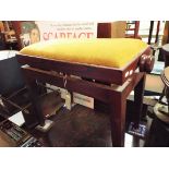 A rectangular mahogany framed adjustable piano stool