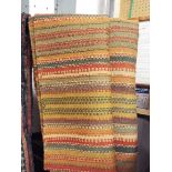 A green ground geometrically woven kilim runner,