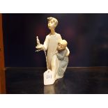 A Nao figurine of a 'Brother & Sister With Candlestick',