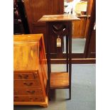 An arts and crafts mahogany plant stand having heart shaped frieze with under-tier resting on