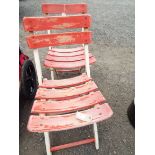 A pair of painted teak folding garden chairs