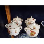 Four J Chomette Pilivite two handled lidded soup bowls with fruit and nut decoration