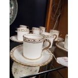 Eight Adderley ware coffee cans and seven saucers decorated with gilt borders and handles