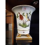 A Heron transfer-printed vase with hand painted colour bird decoration resting on four claw feet