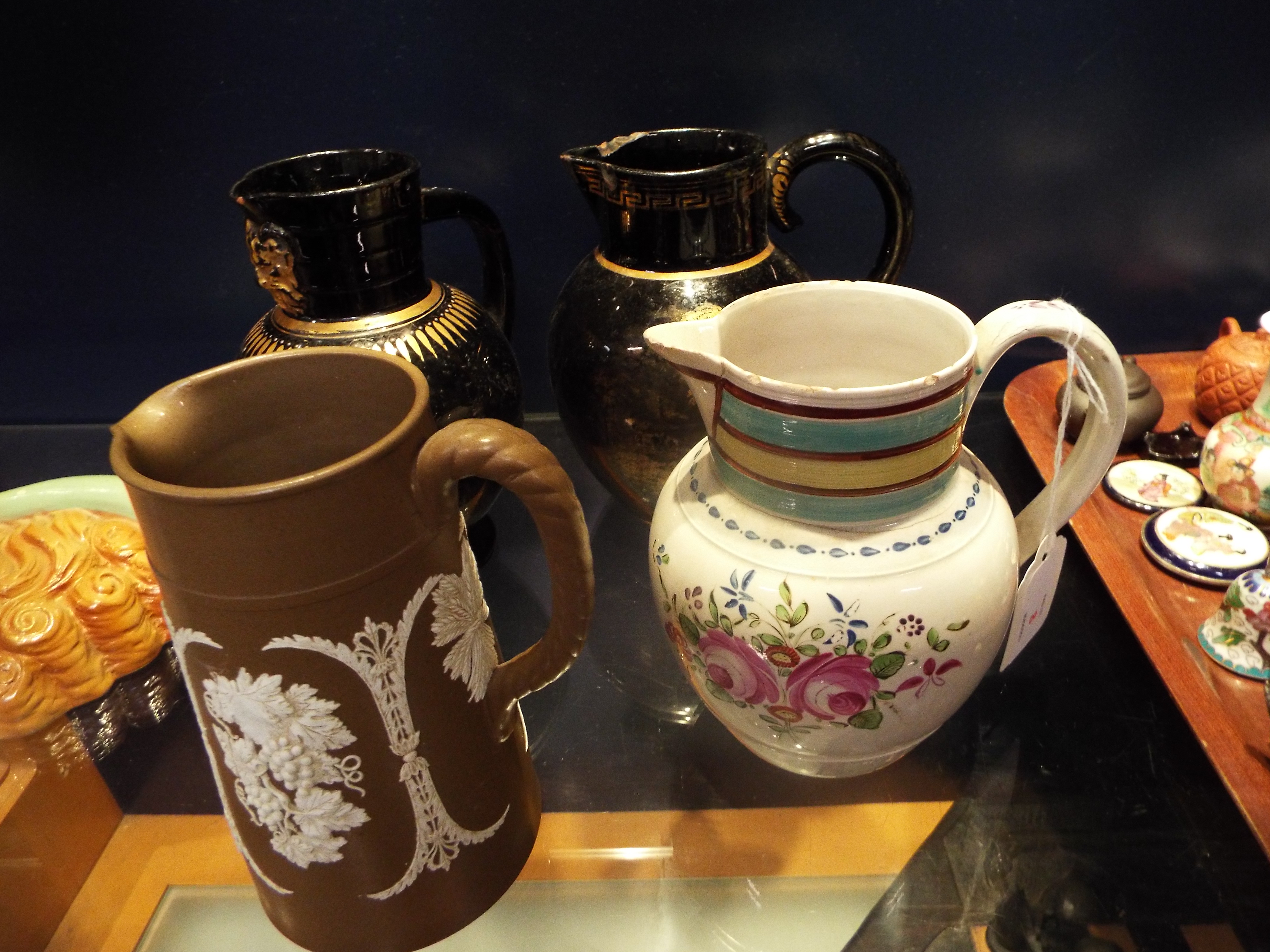 A cream-ware jug with floral decoration,