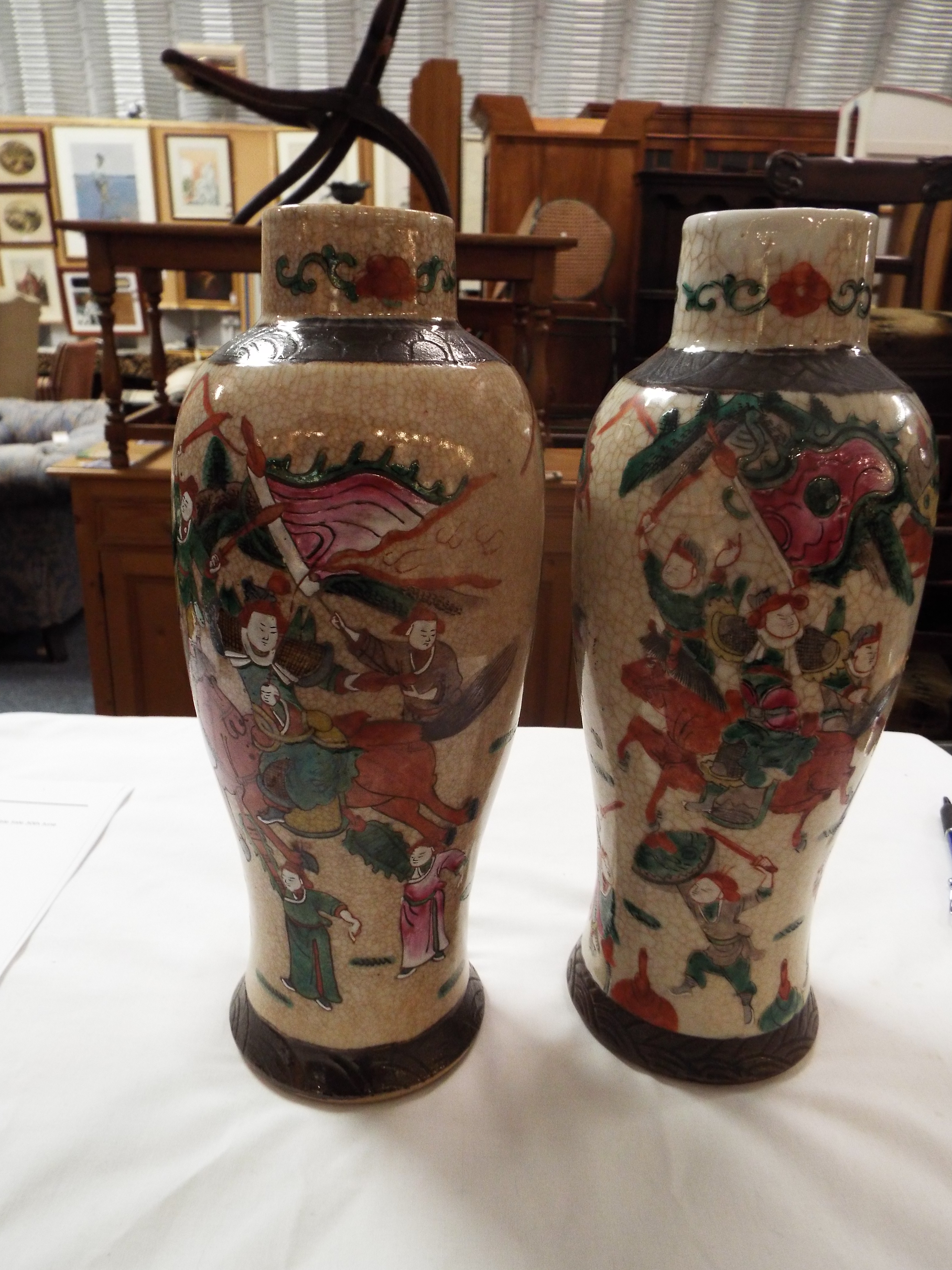 A pair of early 20thC crackle glazed Japanese vases of baluster form enamelled with battling - Image 3 of 7