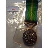 A Malaysian Dedicated Service medal with ribbon