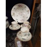 Three Clarice Cliff tea cups and saucers and matching plate,